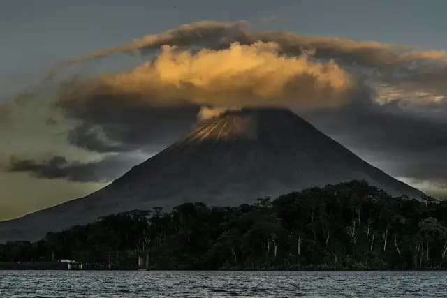 Arenal Volcano rising above the Costa Rican rainforest at dusk