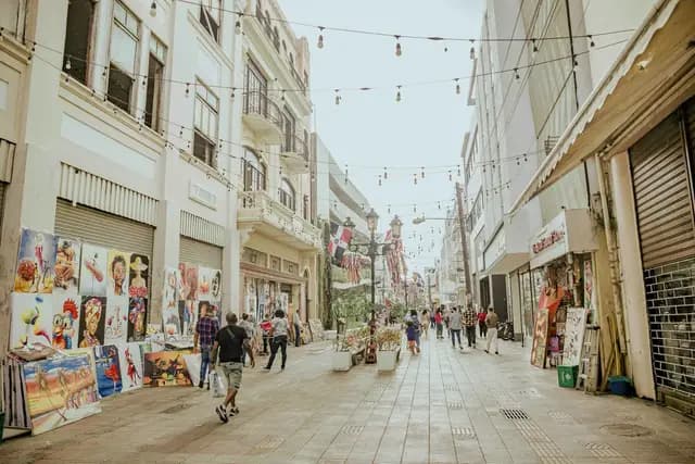 People walking through a colourful street in the Colonial Zone, Dominican Republic